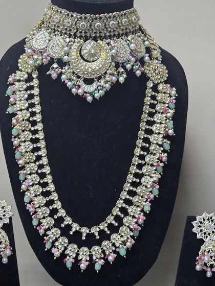A beautiful pastel-colored set with a choker and matching rani haar, featuring a unique crescent moon design.