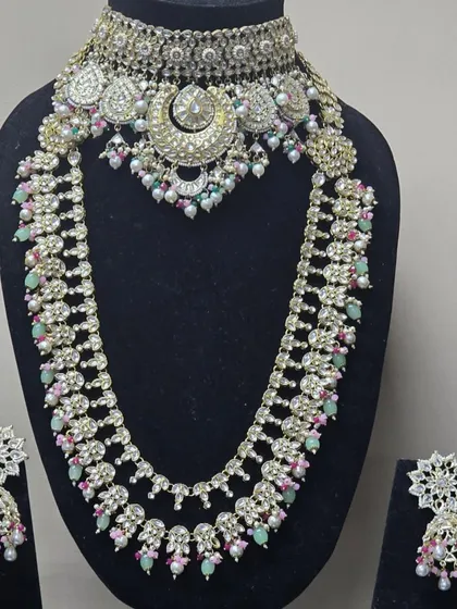 A beautiful pastel-colored set with a choker and matching rani haar, featuring a unique crescent moon design.