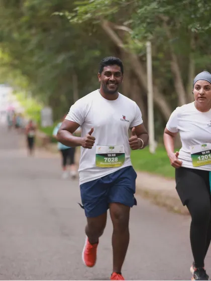 Coach Shushanth leading by example during the Mysuru Run, encouraging a team member to keep pushing forward. We train with you and run with you.
