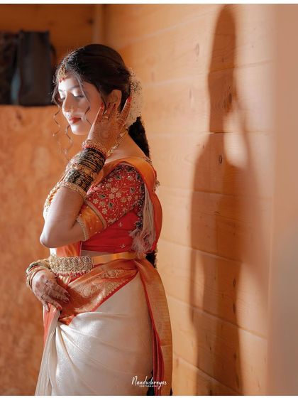 A pensive and artistic portrait of the bride against a wooden wall. The play of light and shadow adds depth and emotion to the image.