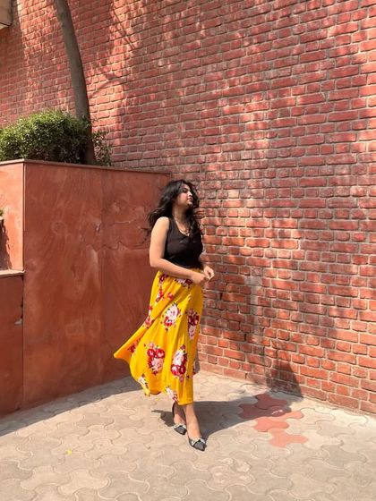 Another angle of the yellow floral skirt outfit, showing how beautifully it moves. A flowy skirt is a must-have for comfortable and stylish summer dressing.
