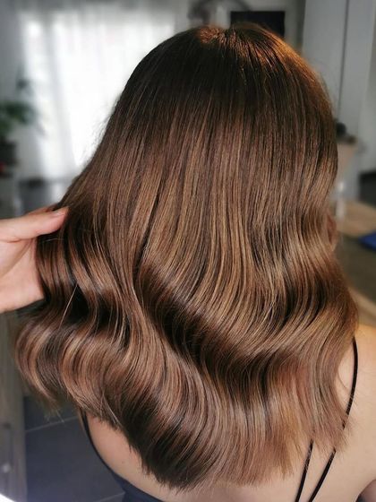 A stunning caramel brunette look. I used a root shadow and a toner with Wella Professionals to create this seamless, glossy finish with beautiful caramel tones.