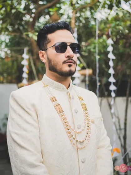 The groom's style is just as important. This shot captures Aditya's cool demeanor and his layered pearl necklace.
