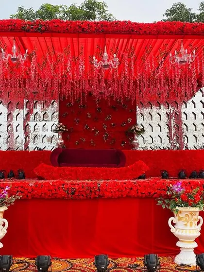 A frontal view of another all-red stage design, this one featuring a silver patterned backdrop for a modern touch.