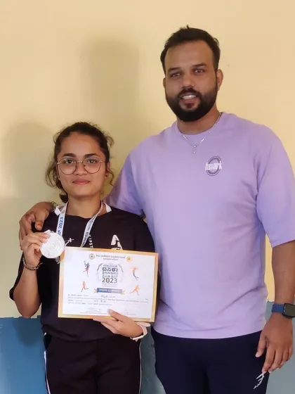A silver medal for this talented female lifter, contributing to our team's overall championship win.