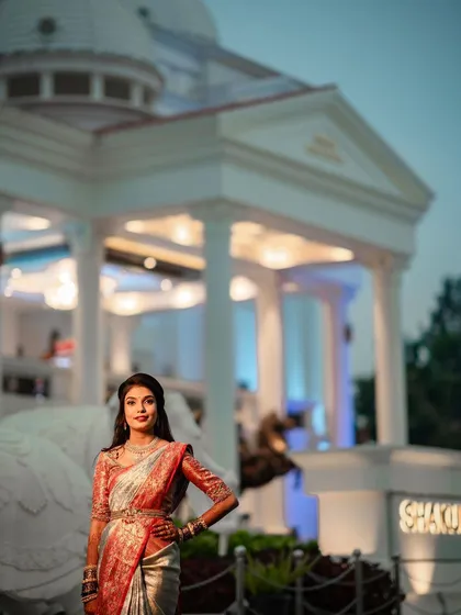 Swathi at her reception venue. The glamorous makeup looks stunning against the evening lights, creating a truly mesmerizing bridal portrait.