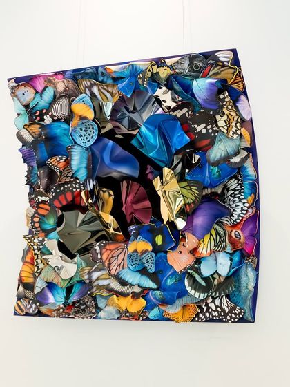 The angle of this shot shows the depth of the piece, with layers of wings creating shadows and highlights.