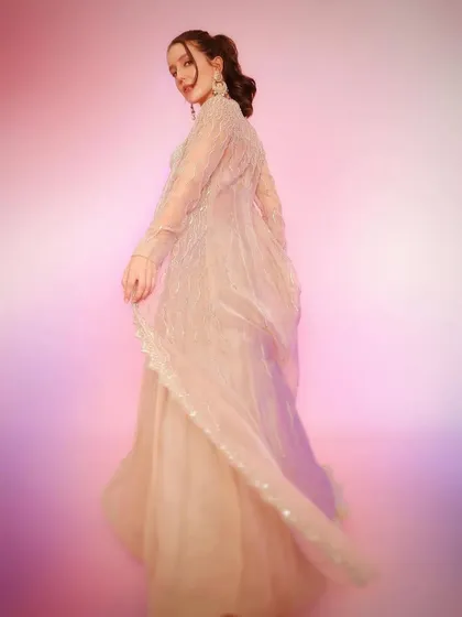 The sheer jacket of this Rishi and Soujit outfit catches the light beautifully, making it an ethereal and elegant choice for any special occasion.