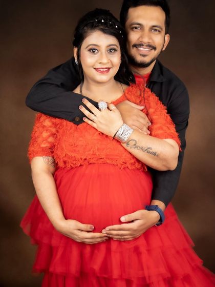 Another happy portrait of the expecting couple. Her makeup is natural and glowing, perfect for celebrating their journey to parenthood.