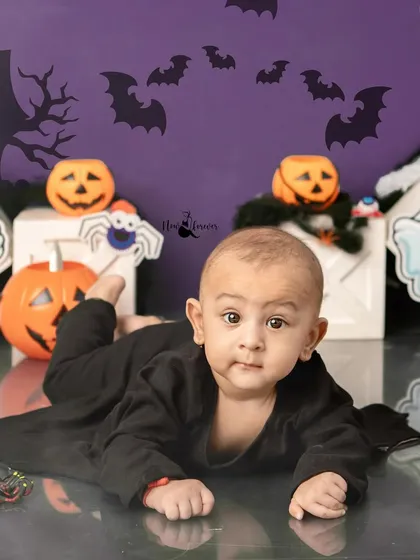 This little one is curiously exploring the spooky Halloween set. The safe and fun environment allows for great candid shots.