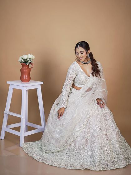 A full shot of the all-white chikankari-style lehenga. Its timeless elegance makes it a versatile rental for many different occasions.