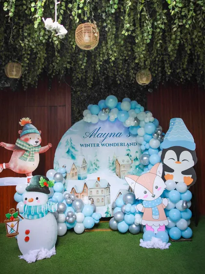 Welcome to a Winter Wonderland. This theme features adorable animal cutouts like a fox and snowman, and a beautiful balloon arch in shades of icy blue and silver to create a magical, snowy scene.