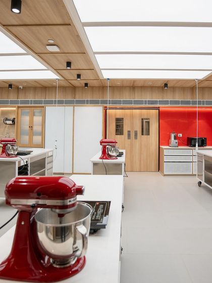 A close-up of a workstation, complete with a stand mixer and induction cooktop.