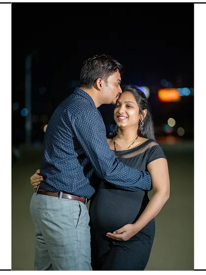 A happy moment captured during a night shoot, with the city lights creating a beautiful bokeh effect in the background.