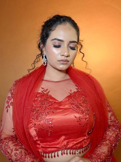 A view of the glossy eye makeup with her eyes closed. The blend of colors and the high-shine finish create a very modern and glamorous effect.