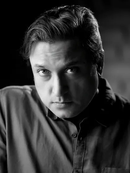An intense, dramatic black and white portrait of Sanjev Sharma. The close crop and direct gaze make this a very powerful headshot.