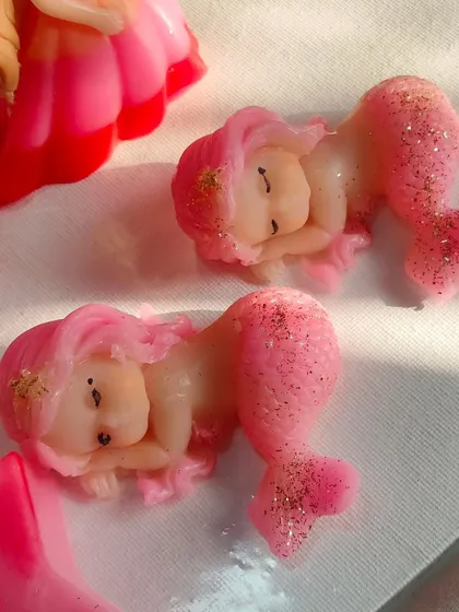 Adorable sleeping mermaid baby soaps with glittery tails. These are perfect for a mermaid or under-the-sea themed party.