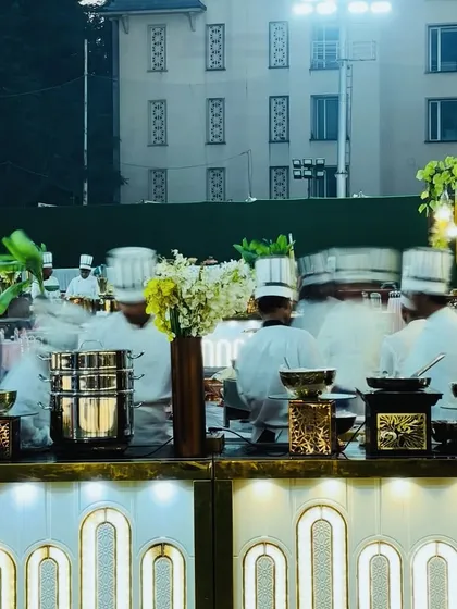 My team in action behind our elegant white and gold buffet. This setup is perfect for modern weddings and upscale parties, combining functionality with a chic aesthetic.