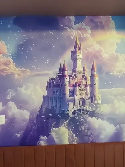 A magical fantasy castle mural, complete with clouds and a rainbow. This type of custom wallpaper can turn any room into a fairytale scene for children to enjoy.
