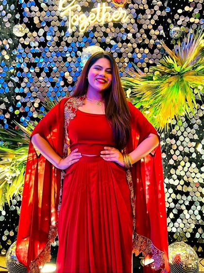 A dazzling red outfit for a glamorous cocktail night. The sparkly backdrop perfectly complemented my look.