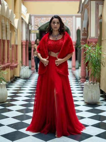 Get the fashion glam look with this red three-piece set, featuring a sequin top, tulle skirt, and faux fur shrug.