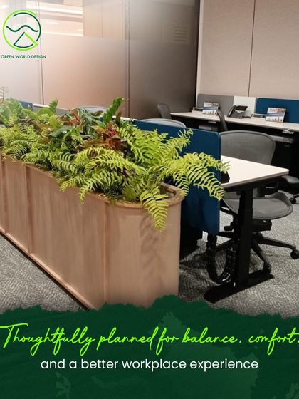 Ferns in a copper-toned planter add texture and a touch of nature to the desking area. This thoughtful placement provides a visual break for employees and helps to define the workspace.