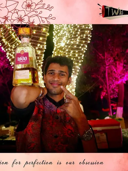 A bartender proudly displays a bottle of premium 1800 Tequila, ready to craft the perfect margarita or picante.