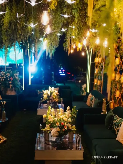 An elegant outdoor lounge with emerald green velvet sofas and lush floral arrangements. I create comfortable and stylish seating areas where guests can relax and socialize in a beautiful setting.