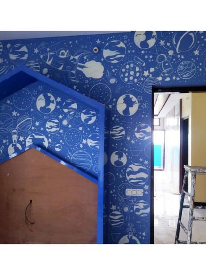 This was one of our most challenging and favorite kids' room projects. We filled the entire wall with a dense doodle of planets, stars, and astronauts. It was a lot of work on a ladder, but the result was a room full of wonder.