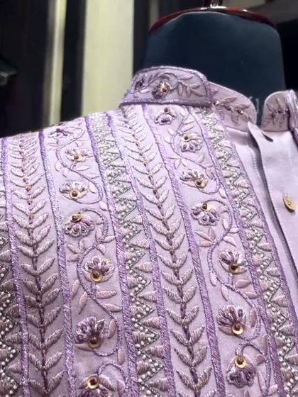 Every thread whispers tales of tradition and refinement. This jacket features intricate floral and vine embroidery.