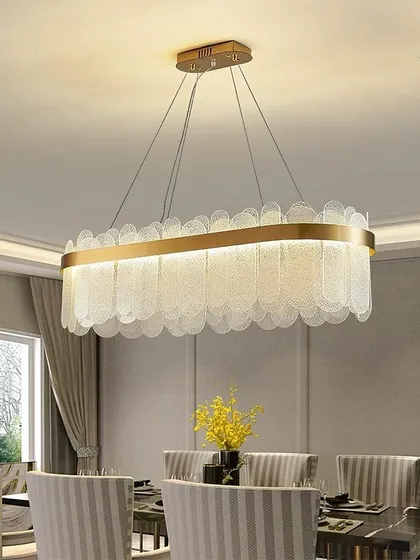 This elegant rectangular chandelier features scalloped glass pieces that create a soft, textured light. It's an ideal choice for hanging over a formal dining table.