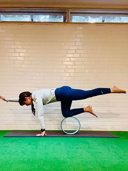 Flowing into the weekend with a balancing pose using the yoga wheel for support. This prop helps stabilize the knee, allowing for a deeper focus on alignment and breath.