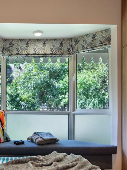 The bespoke bay window nook in the Valley of Dreams kids' room frames a breathtaking Himalayan view. Wrapped in foliage-printed drapes, it offers the perfect perch for reading, daydreaming, or simply watching the clouds roll by.