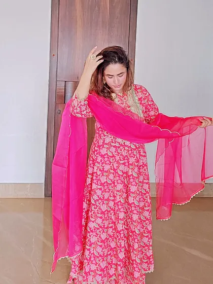 A floral printed Anarkali suit is both comfortable and incredibly chic. This vibrant pink ensemble is perfect for a festive lunch or a daytime ceremony, offering a beautiful flow and feminine charm.
