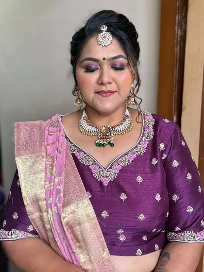 A close-up of the makeup, showing the soft purple smokey eye and flawless base.