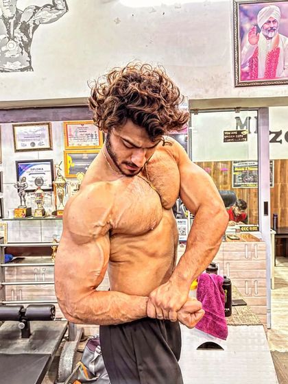 A side chest pose showing the thickness of my pecs and the size of my arms. This is a power pose that displays pure mass.