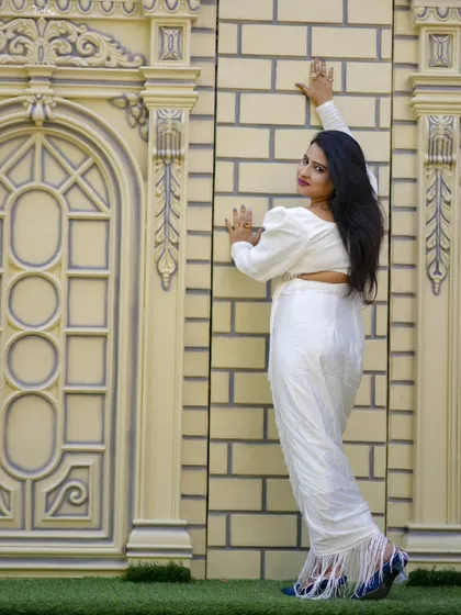 A graceful pose against an elegant, carved wall. This location is perfect for creating sophisticated and artistic portraits.