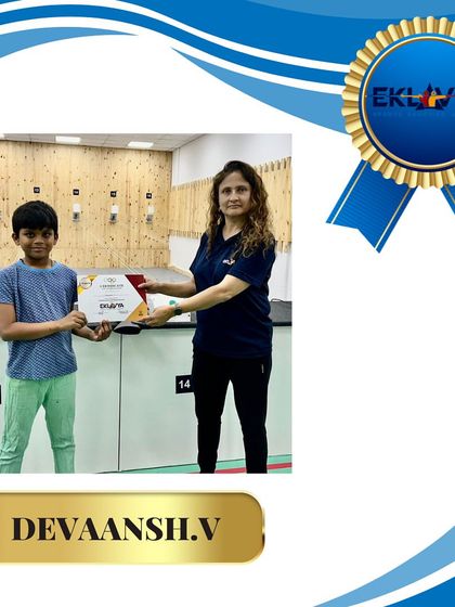 A coach congratulates Devaansh V. on his achievement. We ensure every student feels valued and celebrated for their dedication.