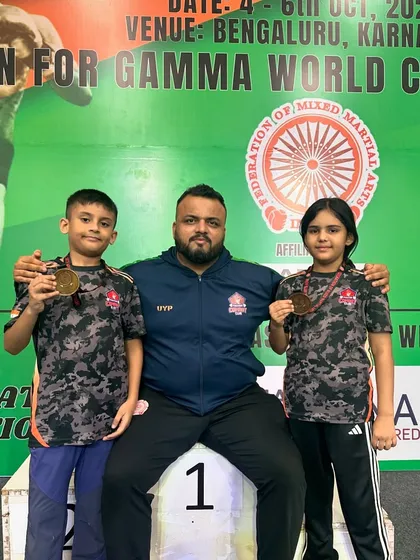 Me on the podium with my two junior champions, Shivam and Mishty, after they won gold at the FMMAI National Championship, securing their spot for the World Championship.