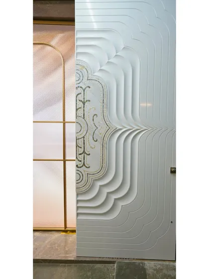 This is not just a door; it's a piece of art. We used premium Corian material and precision CNC cutting to create this stunning door with flowing, layered contours and ornamental details.