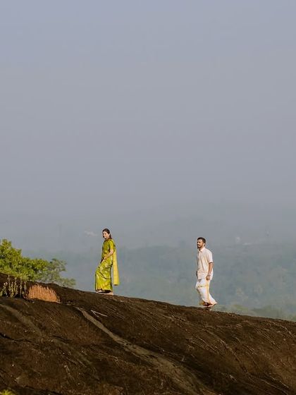 A minimalist composition, with the couple walking along the ridge of the hill, emphasizing the vastness of the landscape.
