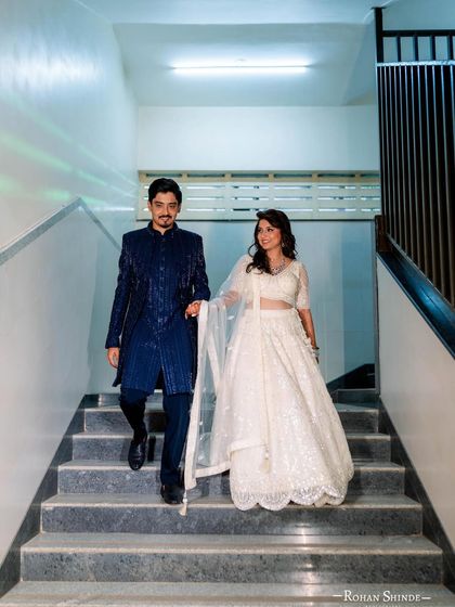 Another shot of my client in the royal blue sherwani, descending the stairs with his partner. It’s a candid moment that shows how great the outfit looks in motion.