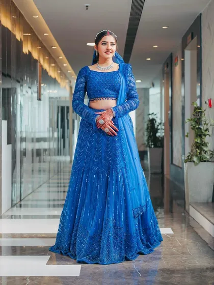Seeing my client shine in this custom royal blue lehenga is what it's all about. This piece features full-sleeve detailing and head-to-toe sequin work, making it a perfect, modern choice for a sangeet or reception.