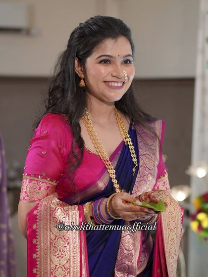 A candid moment of joy during the engagement ceremony. The makeup is designed to look flawless from every angle, both in person and in photos.