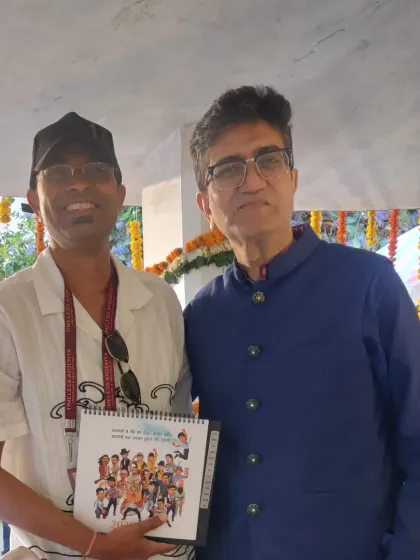 With a guest at the Timeless Ayodhya Festival, holding a copy of my Aamir Khan calendar.