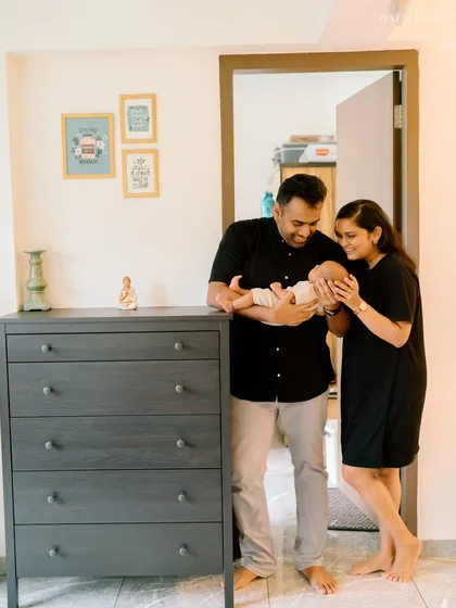 In this at-home lifestyle shot, both parents admire their newborn together. These unposed moments in your own space result in truly personal and heartfelt family photographs.