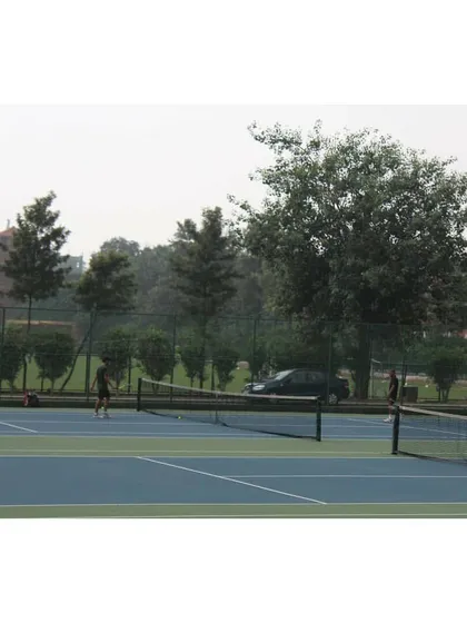 Players competing on one of our fenced courts at the Modern School venue. The setup ensures an uninterrupted and safe playing environment for all tournament participants.