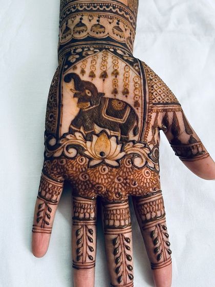 A close-up of a majestic elephant design on the palm, a very popular and auspicious motif for bridal mehendi.