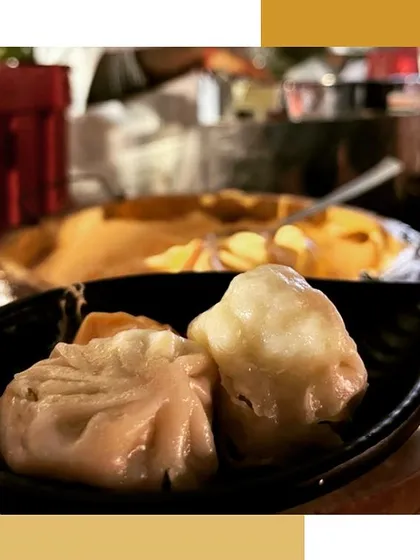 A close-up of delicate, steamed dim sum, showcasing the perfect folds and juicy filling.