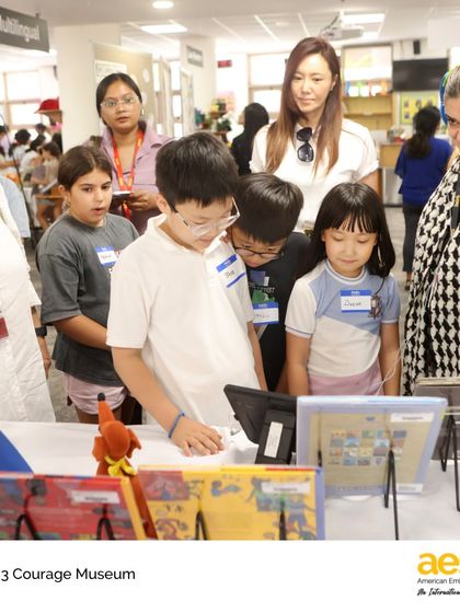 Parents and students explore the diverse exhibits at the Grade 3 Courage Museum. The event showcased student research on courageous figures through written biographies, interviews, and creative displays.